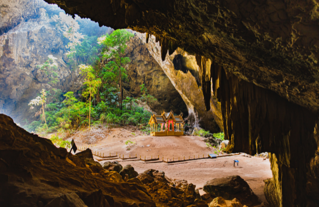 Phraya Nakhon Cave with sunlight illuminating the golden royal pavilion inside